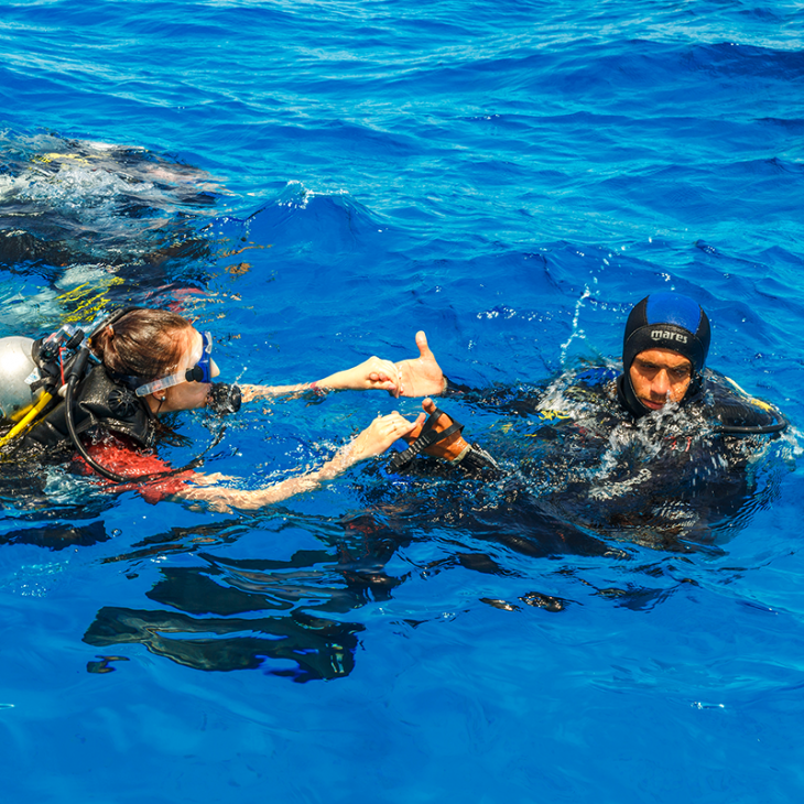 An instructor helps one of his student scuba divers out in Playa del Carmen